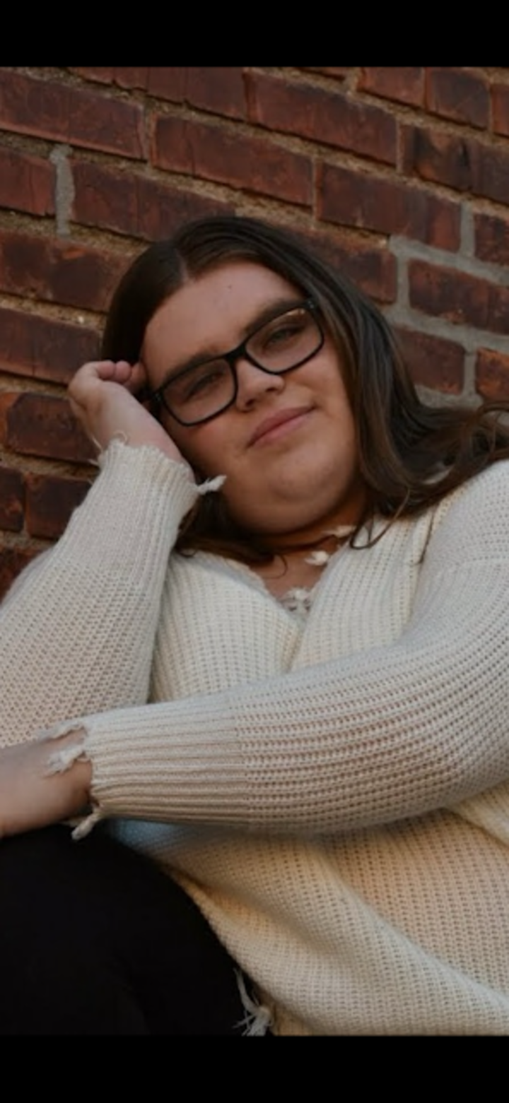 Woman with brown hair and glasses